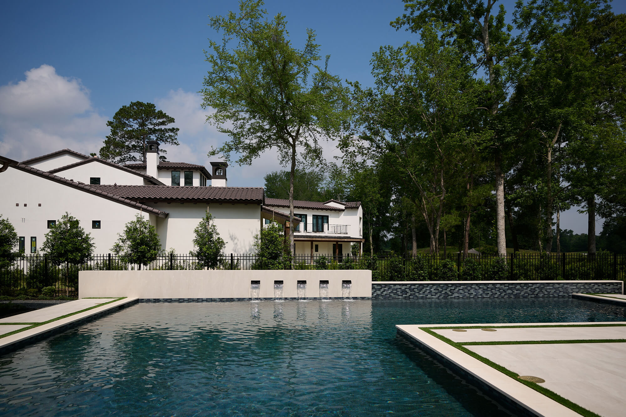 outdoor-pool-spa-water-features outdoor pool and spa with water features on a hot sunny day