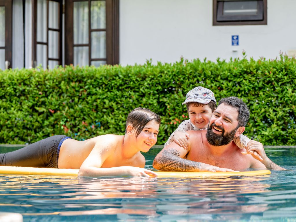 11 Essential Pool Safety Tips for Parents and Children 1 adult with kids on swimming pool