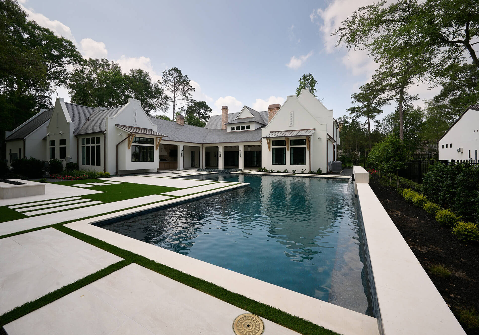 outdoor pool and spa with water features on a hot sunny day
